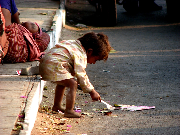 poor child playing in street